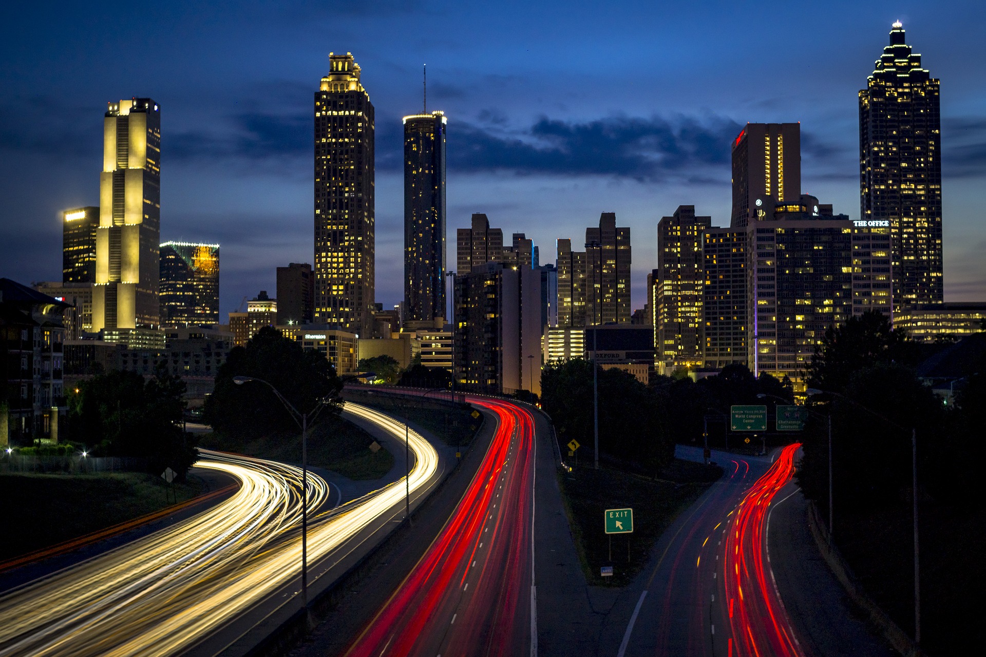 Timelapse photo of a City Interstate and Skyscrapers at Night